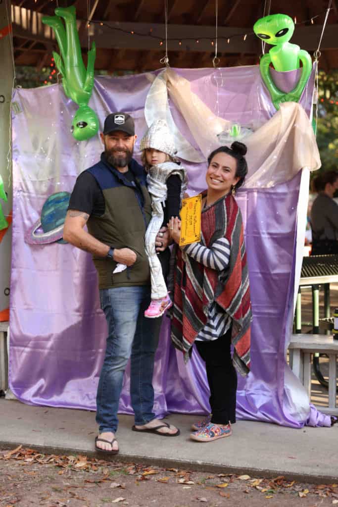 Family picture at the Halloween photo booth in the park